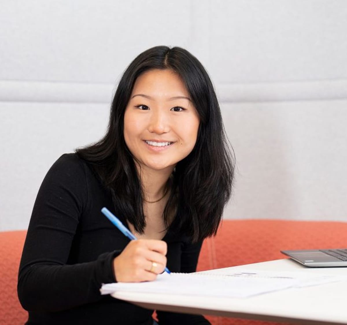Student smiling filling out an application